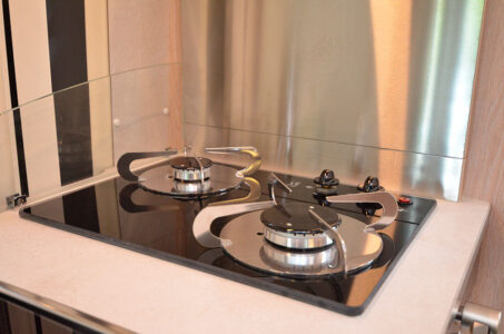 Avec ses feux en saillie et sa plaque de verre, le réchaud rappelle les tables de cuisson domestiques.