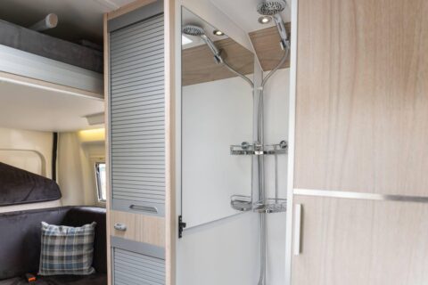 Une petite salle d'eau avec douche, WC et lavabo prend la place de la traditionnelle banquette derrière les sièges route