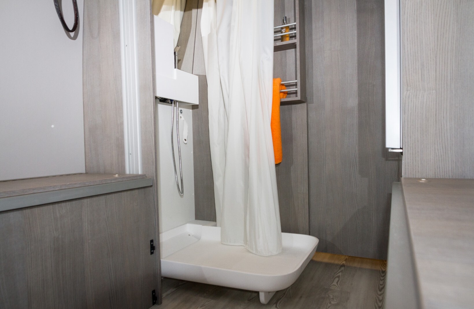 Le rideau de douche en matière imputrescible est lesté en partie basse pour rester positionné dans le receveur.