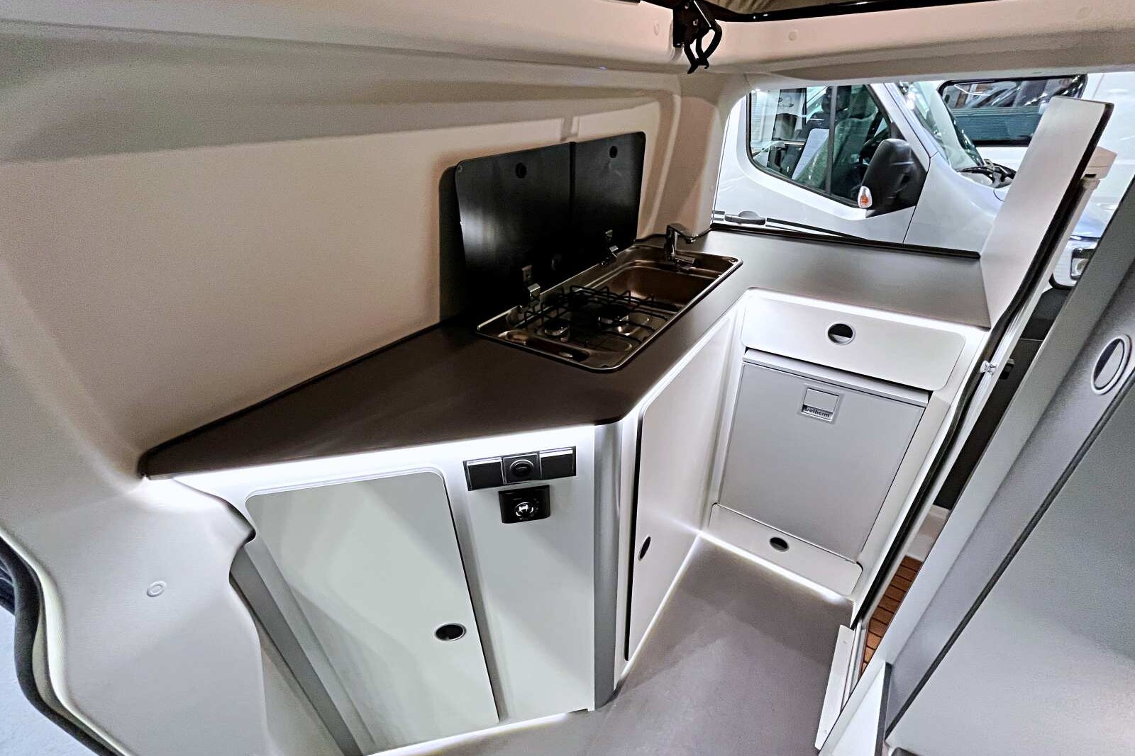 ...le poste cuisine en L se tient à l'arrière avec un frigo de 41 L.